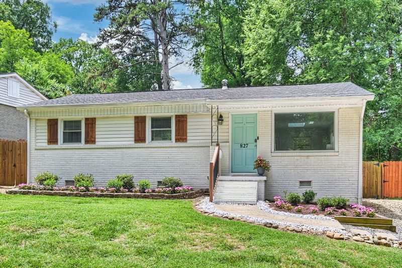 The painted-brick front of 827 Spruce with its landscaped walk