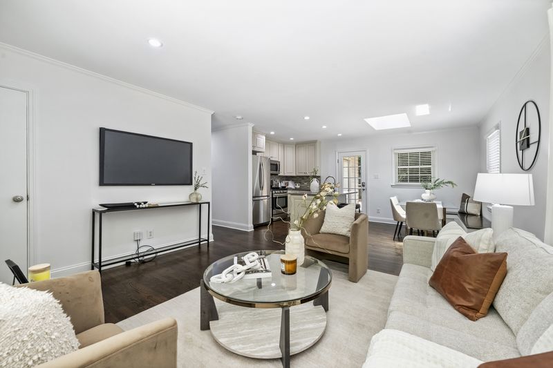 Living room opening to the kitchen and dining beyond