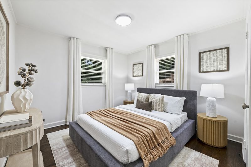 Bedroom with two windows and hardwood floors