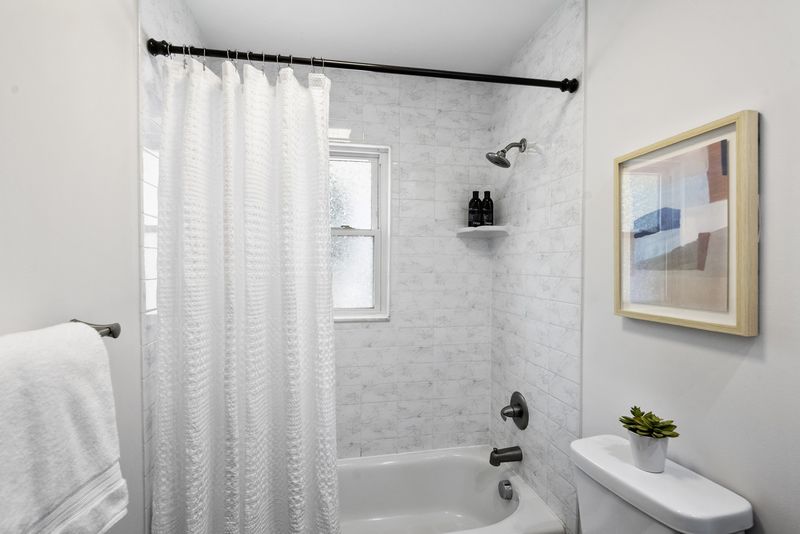 Renovated bath with a subway-tiled tub and shower