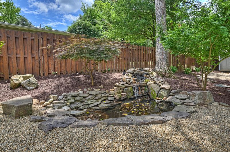 A stone water feature with a waterfall in the back garden