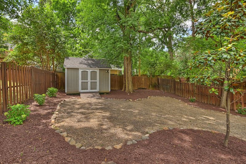 Storage shed in the fenced back yard