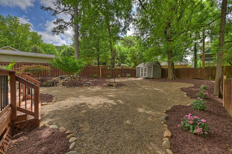 The large, private, tree-shaded back yard