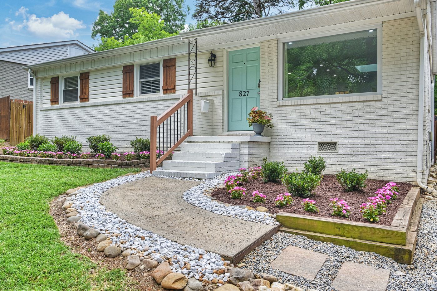 The painted-brick front of 827 Spruce in Wilmore, with a landscaped front walk