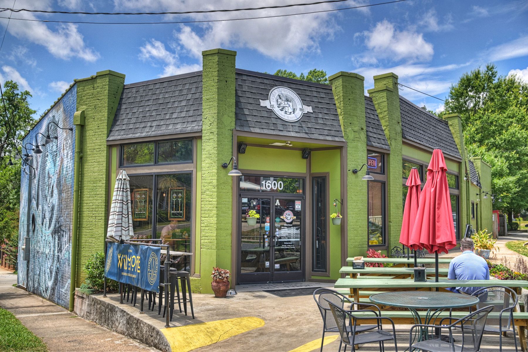 A green-painted corner restaurant and patio in the Wilmore neighborhood