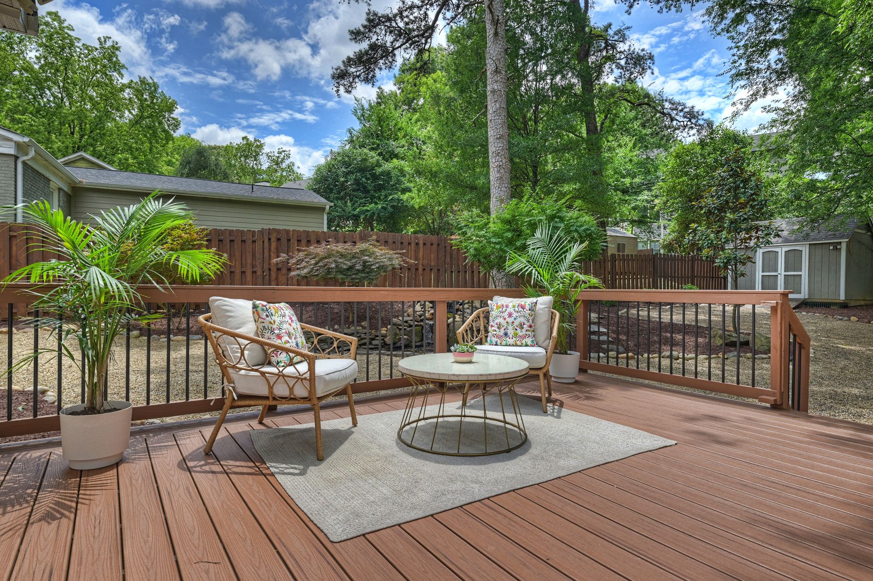 A big deck off the kitchen with a seating area, looking over the yard