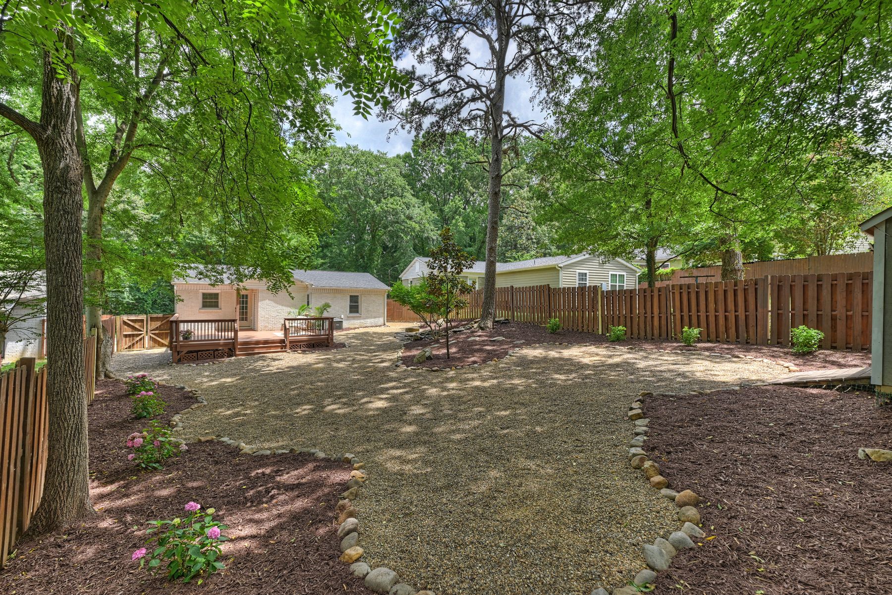 The large, private, tree-shaded and fully fenced back yard
